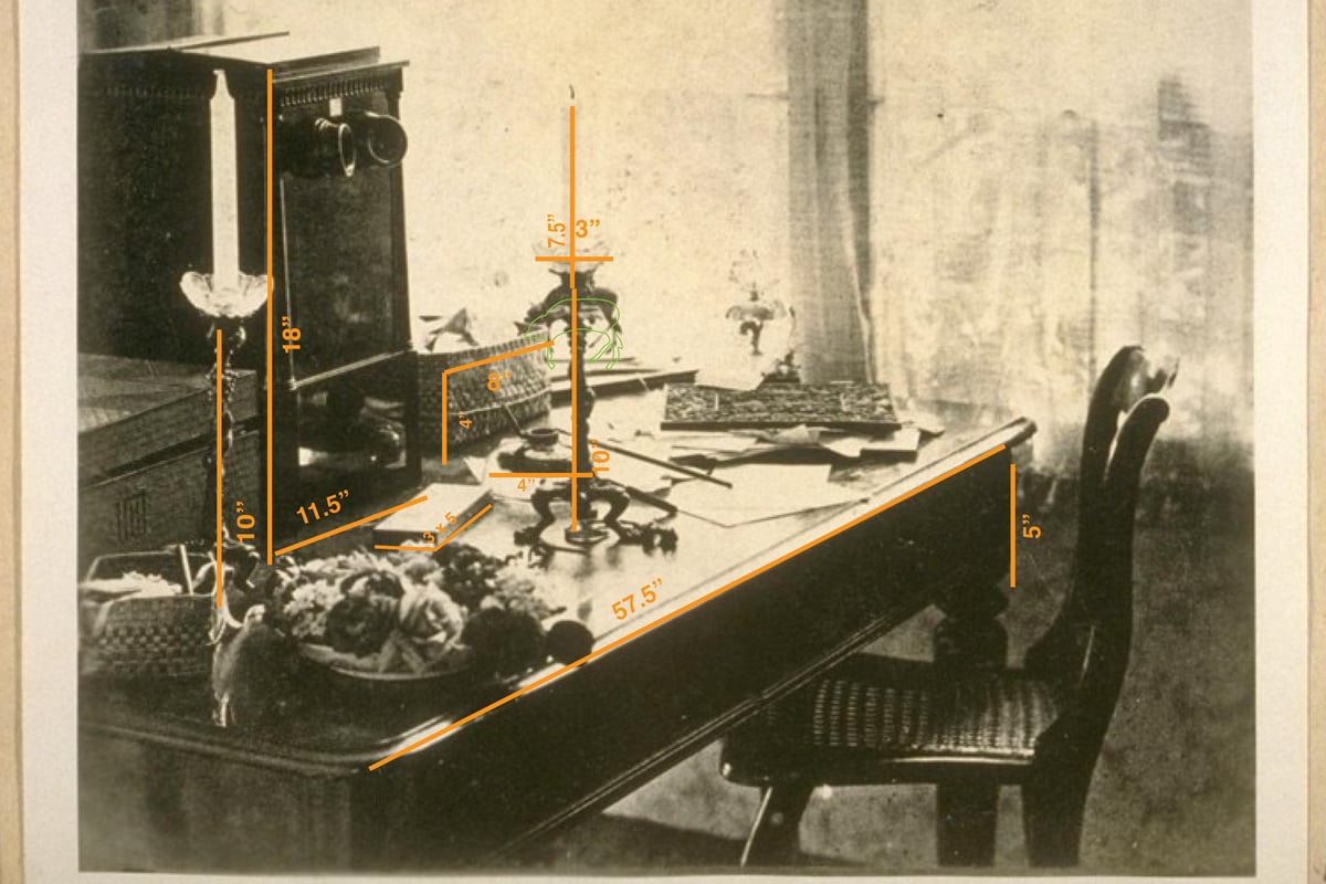 [Obstructed view of the house through the trees with the road visible on the left side in the foreground.] or black point reinterpretive site